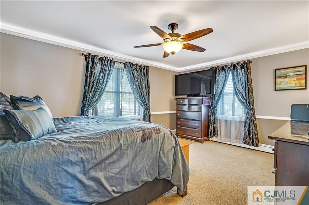 1612 Columbus Road Burlington, NJ 08016 - Photo 11 of 24 a bedroom with a large bed and a chandelier