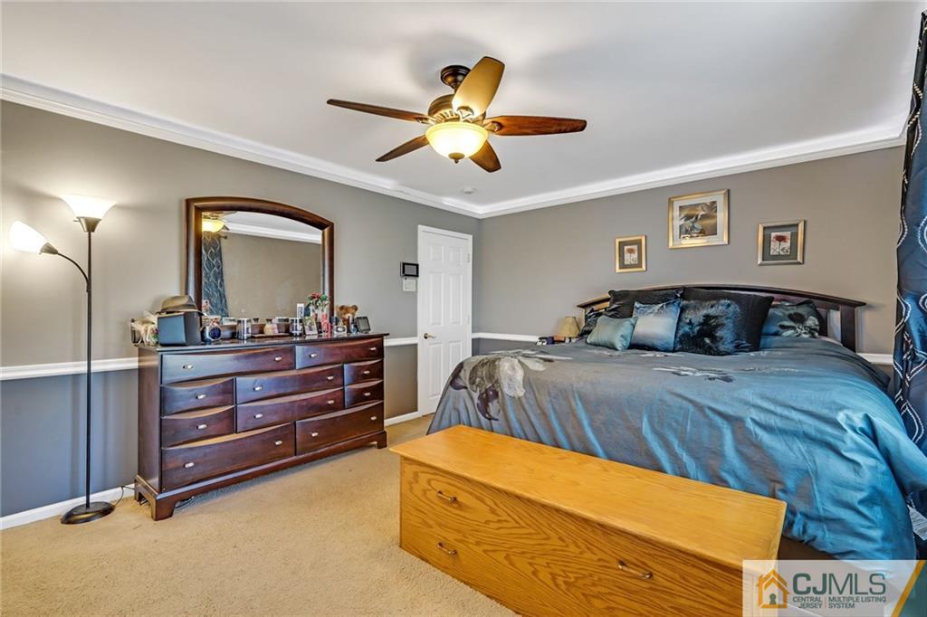 1612 Columbus Road Burlington, NJ 08016 - Photo 12 of 24 a bedroom with a bed and a chandelier