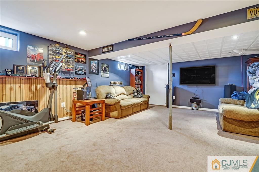1612 Columbus Road Burlington, NJ 08016 - Photo 18 of 24 a bed room with furniture and a flat screen tv