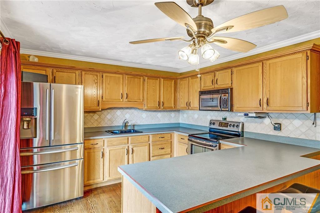 1612 Columbus Road Burlington, NJ 08016 - Photo 8 of 24 a kitchen with a refrigerator a sink and cabinets
