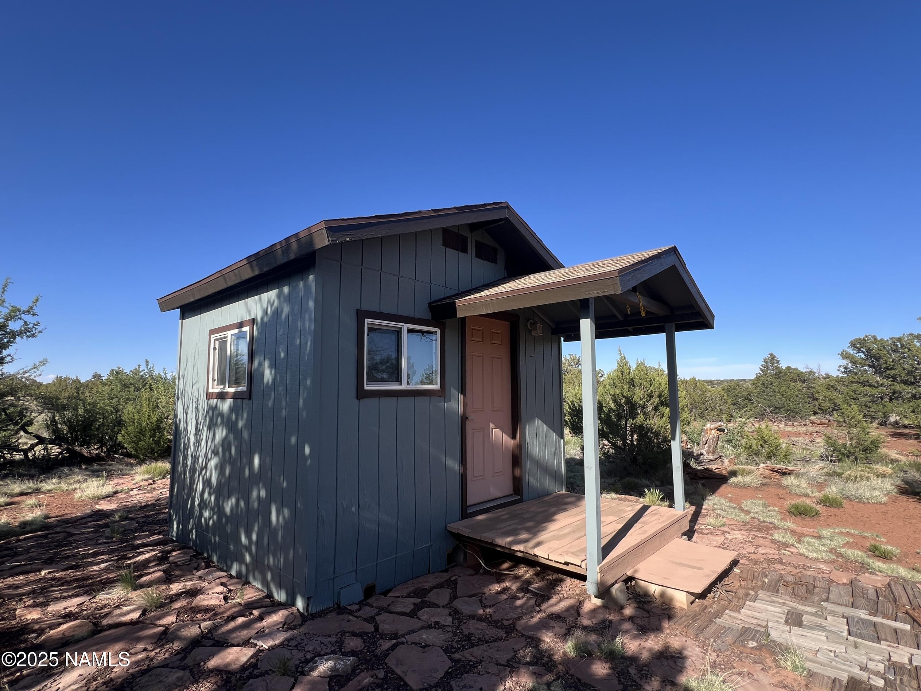 8801 South Rim Ranch Road Williams, AZ 86046 - Photo 3 of 10 a backyard of a house with table and chairs