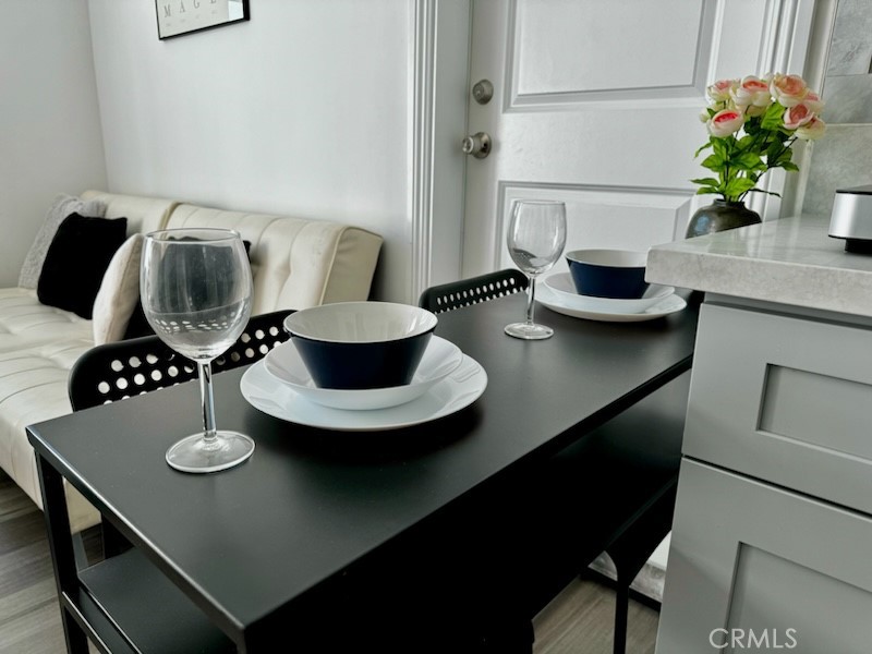 1700 South 8th Street Alhambra, CA 91803 - Photo 5 of 11 a table with chairs and a vase of flowers on it