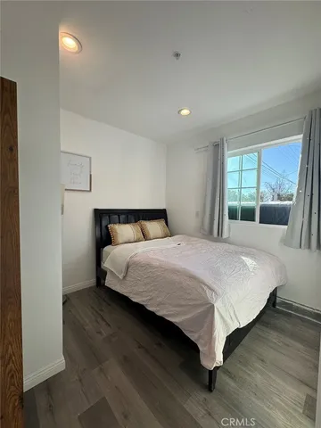 a bedroom with a large bed and a large window