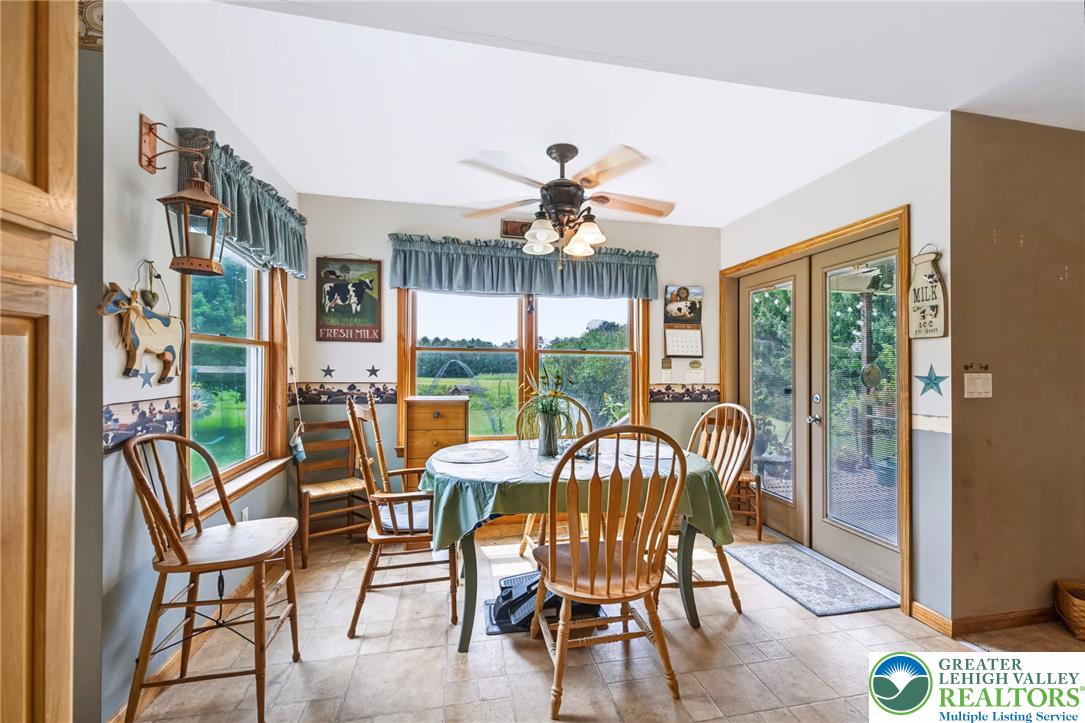 6970 Silver Crest Road Nazareth, PA 18064 - Photo 15 of 35 A charming dining area features a large window with scenic views and convenient outdoor access.