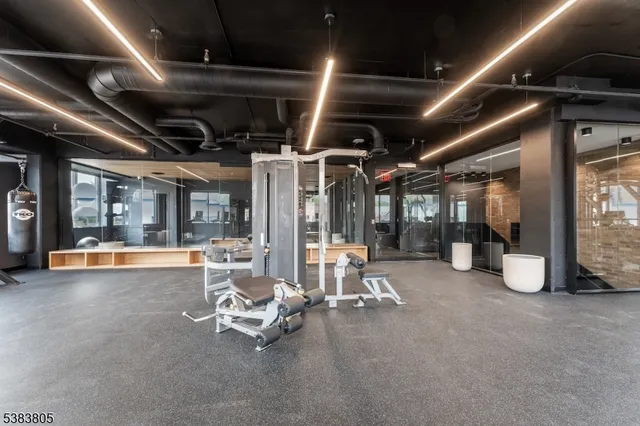 a living room with furniture and a refrigerator
