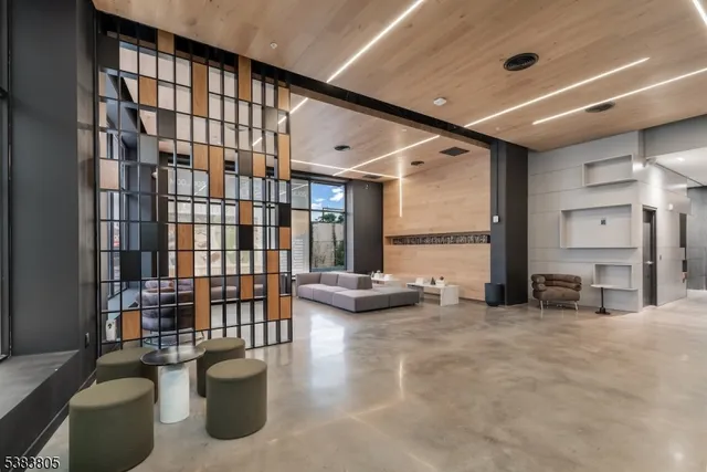 a living room with furniture gym equipment and a large window