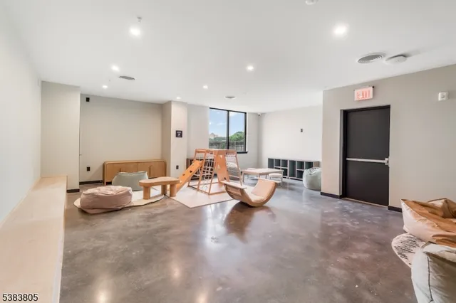 a living room with furniture and large windows