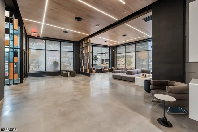 a living room with furniture and large windows