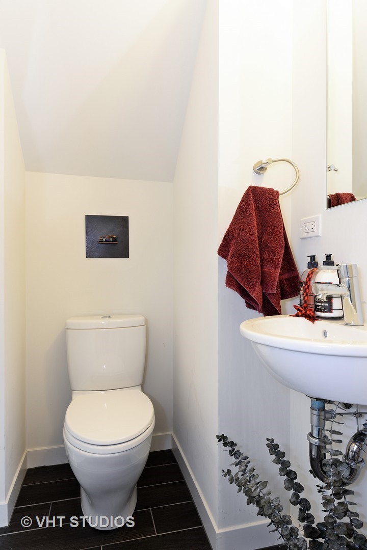 4832 North Clark Street, Unit 101 Chicago, IL 60640 - Photo 11 of 22 a bathroom with a toilet and a sink