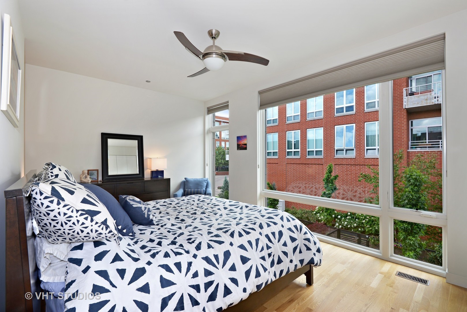 4832 North Clark Street, Unit 101 Chicago, IL 60640 - Photo 14 of 22 a bedroom with a bed and wooden floor