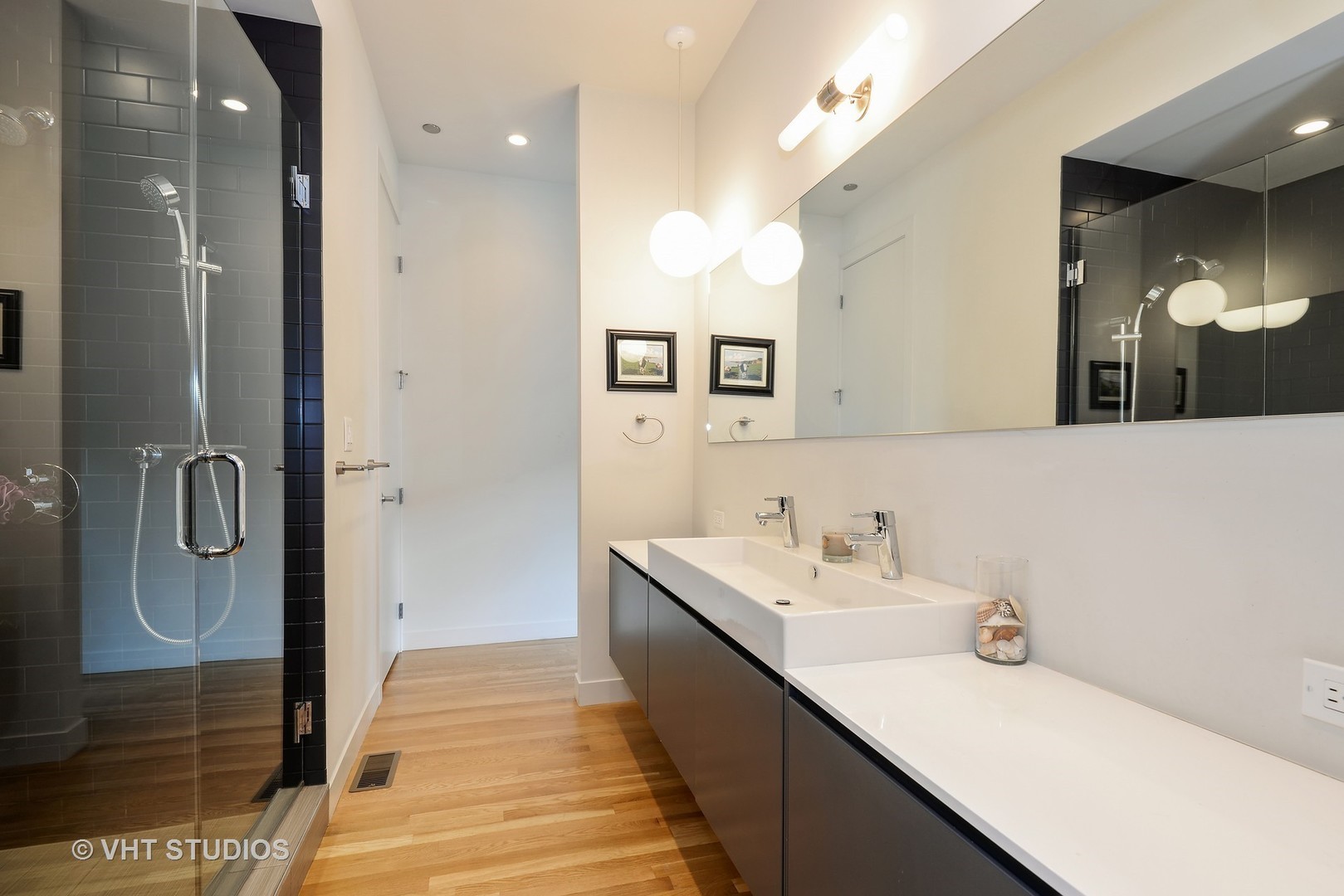 4832 North Clark Street, Unit 101 Chicago, IL 60640 - Photo 16 of 22 a bathroom with a double vanity sink and mirror
