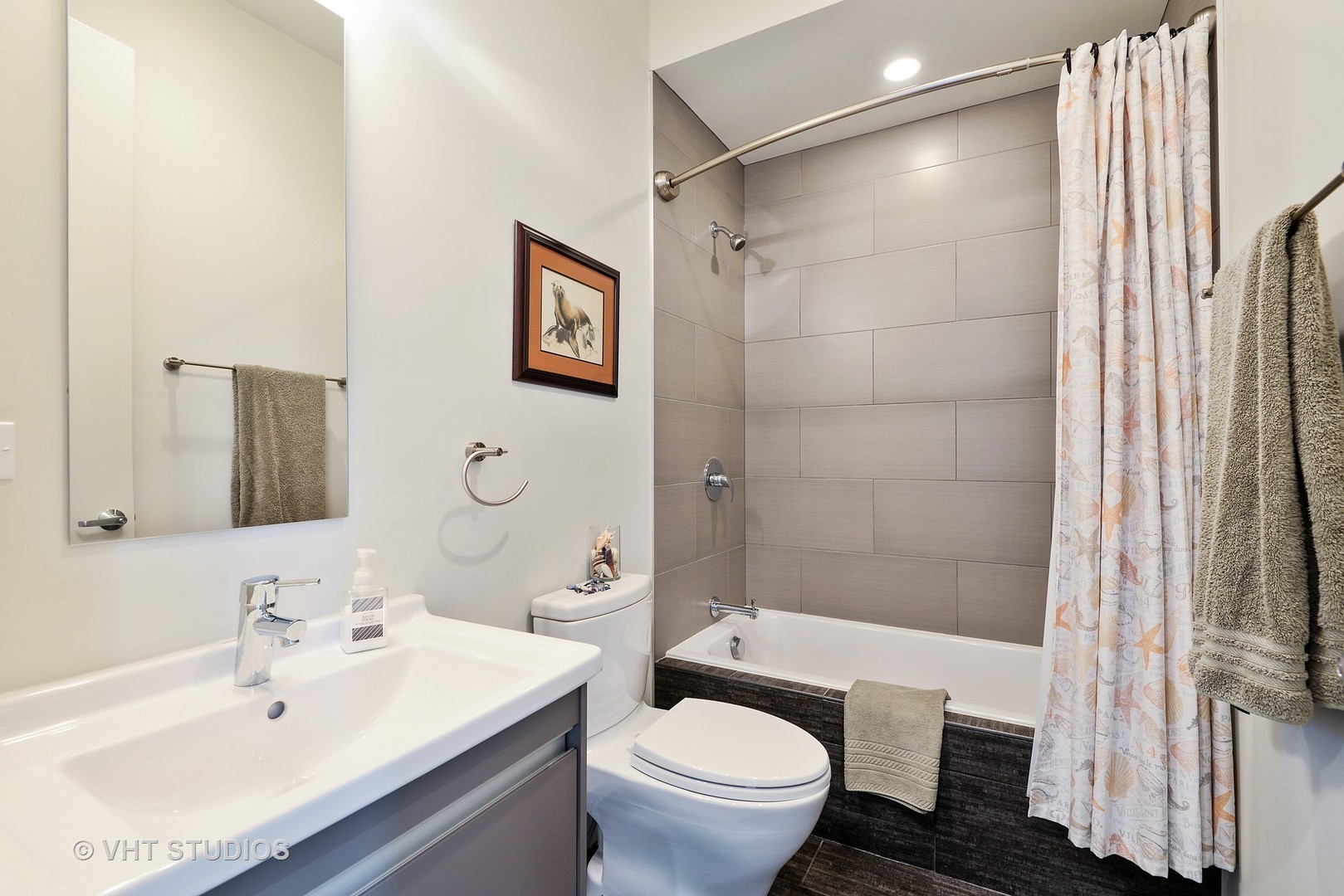 4832 North Clark Street, Unit 101 Chicago, IL 60640 - Photo 18 of 22 a bathroom with a sink toilet and shower