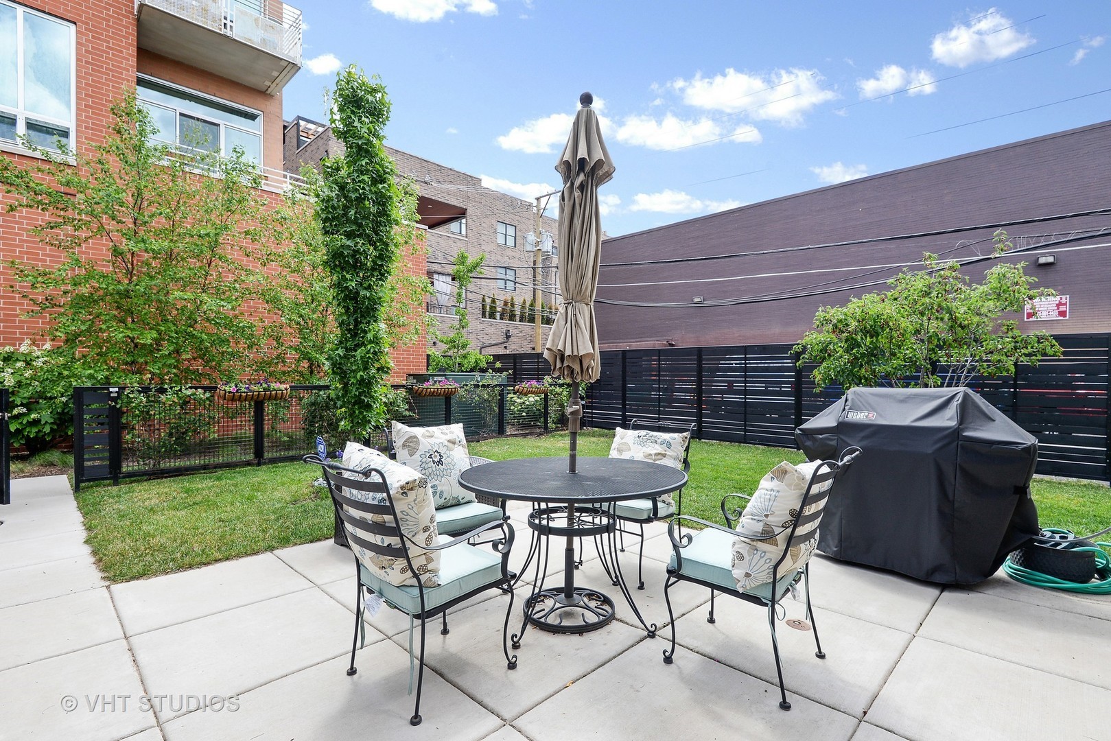 4832 North Clark Street, Unit 101 Chicago, IL 60640 - Photo 20 of 22 a view of a chairs and table in backyard of the house