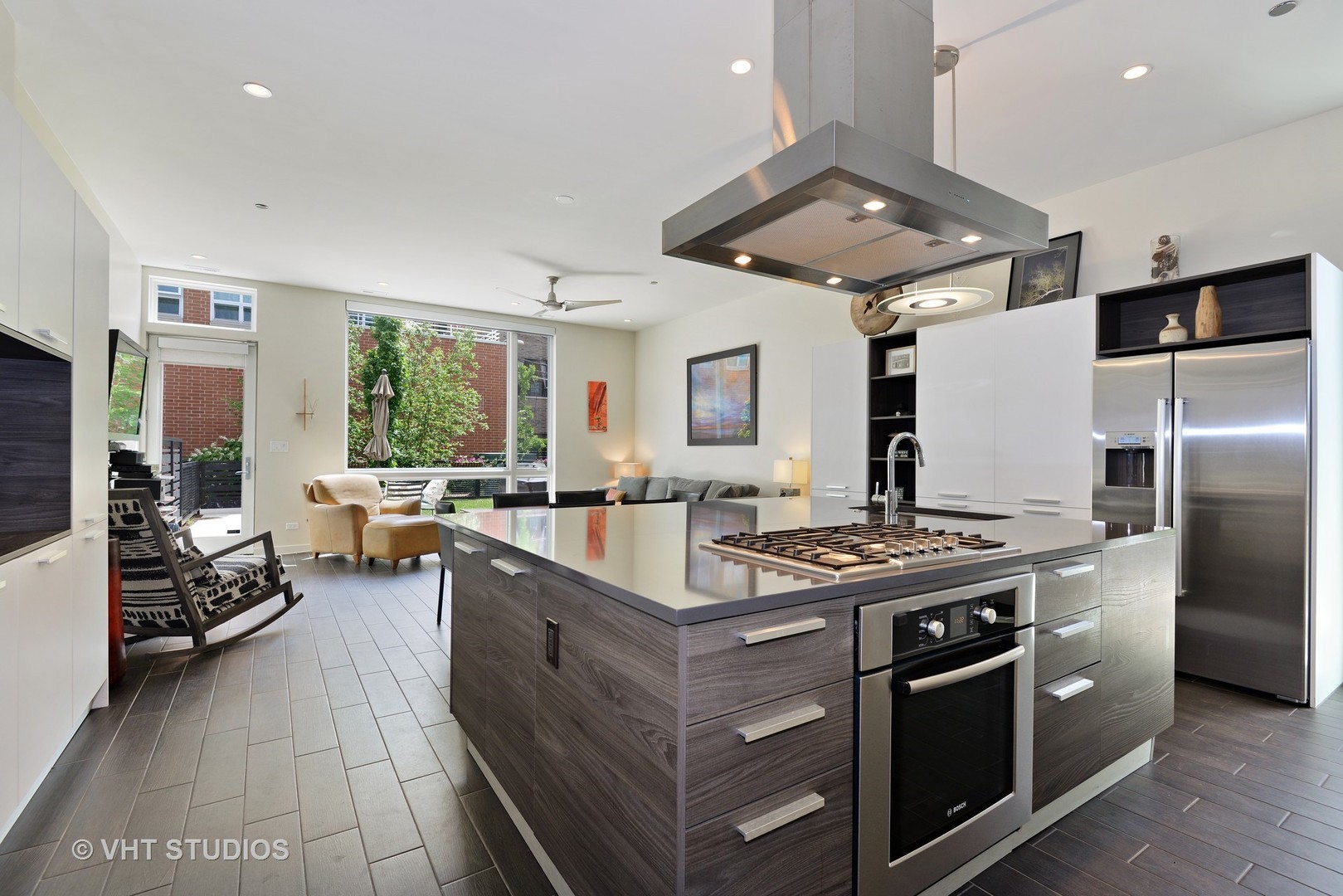 4832 North Clark Street, Unit 101 Chicago, IL 60640 - Photo 4 of 22 a kitchen with stainless steel appliances granite countertop a stove oven and a refrigerator