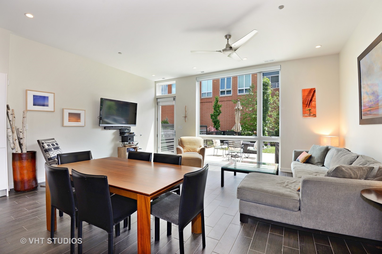 4832 North Clark Street, Unit 101 Chicago, IL 60640 - Photo 9 of 22 a living room with furniture a large window and a flat screen tv