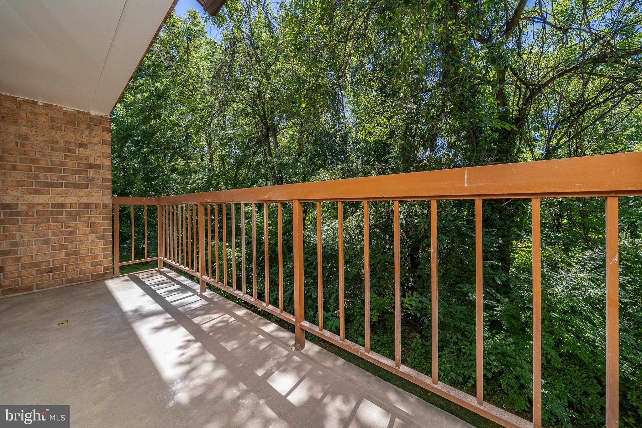 9910 Walker House Road, Unit 99104 Gaithersburg, MD 20886 - Photo 31 of 32 a view of a wooden fence