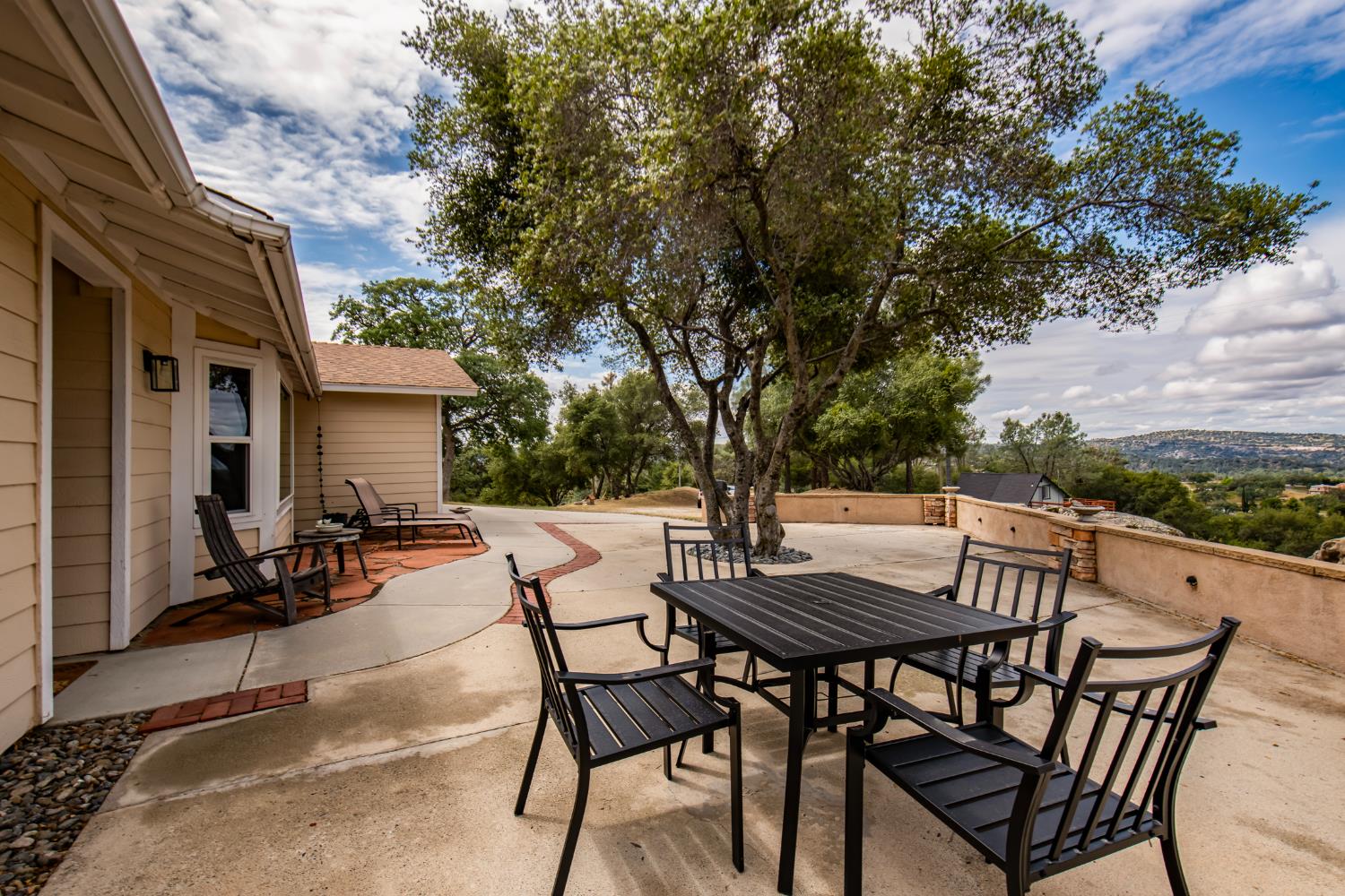 29395 Revis Road Coarsegold, CA 93614 - Photo 25 of 32 a view of backyard with outdoor seating a patio and a garden