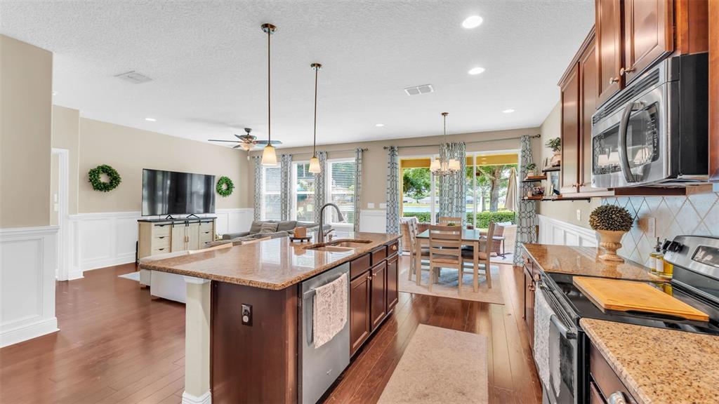 132 Magneta Loop Auburndale, FL 33823 - Photo 14 of 56 a kitchen with stainless steel appliances granite countertop a stove and a sink