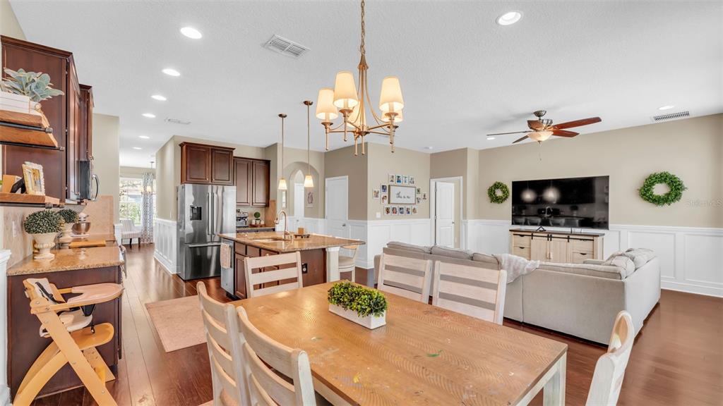 132 Magneta Loop Auburndale, FL 33823 - Photo 17 of 56 a living room with furniture a flat screen tv and kitchen view