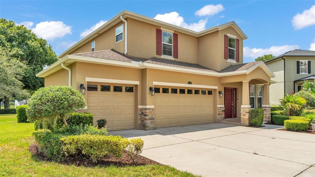 132 Magneta Loop Auburndale, FL 33823 - Photo 2 of 56 a front view of a house with garden
