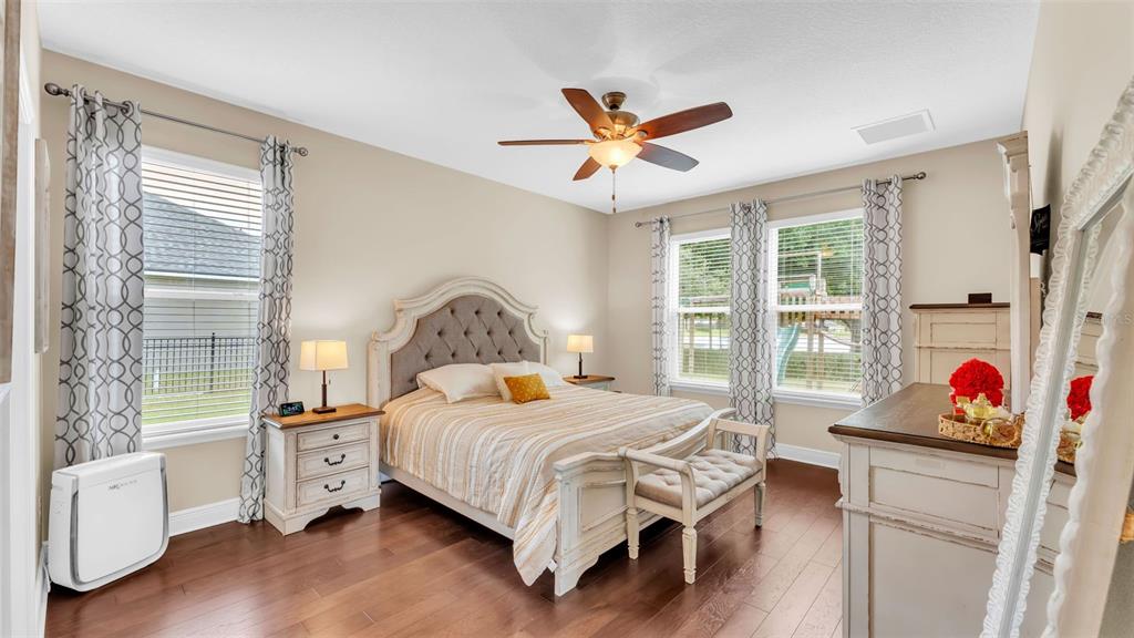 132 Magneta Loop Auburndale, FL 33823 - Photo 22 of 56 a bedroom with a bed and a chandelier