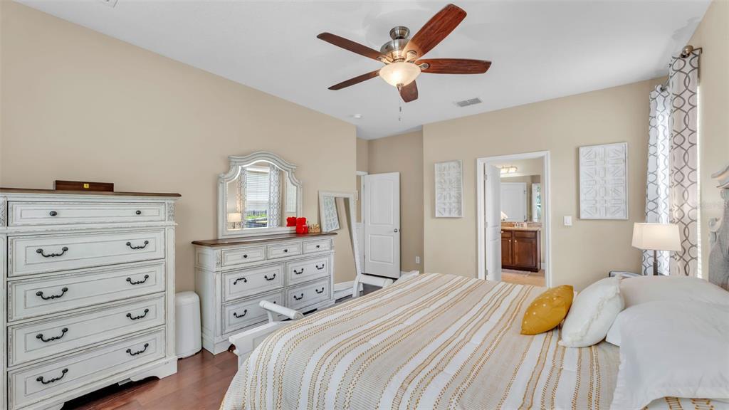 132 Magneta Loop Auburndale, FL 33823 - Photo 23 of 56 a bedroom with a bed and a dresser