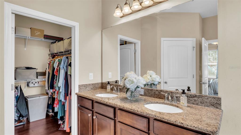 132 Magneta Loop Auburndale, FL 33823 - Photo 25 of 56 a bathroom with a granite countertop sink and a mirror