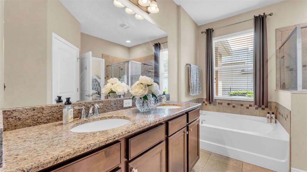 132 Magneta Loop Auburndale, FL 33823 - Photo 26 of 56 a bathroom with a granite countertop sink and a bathtub