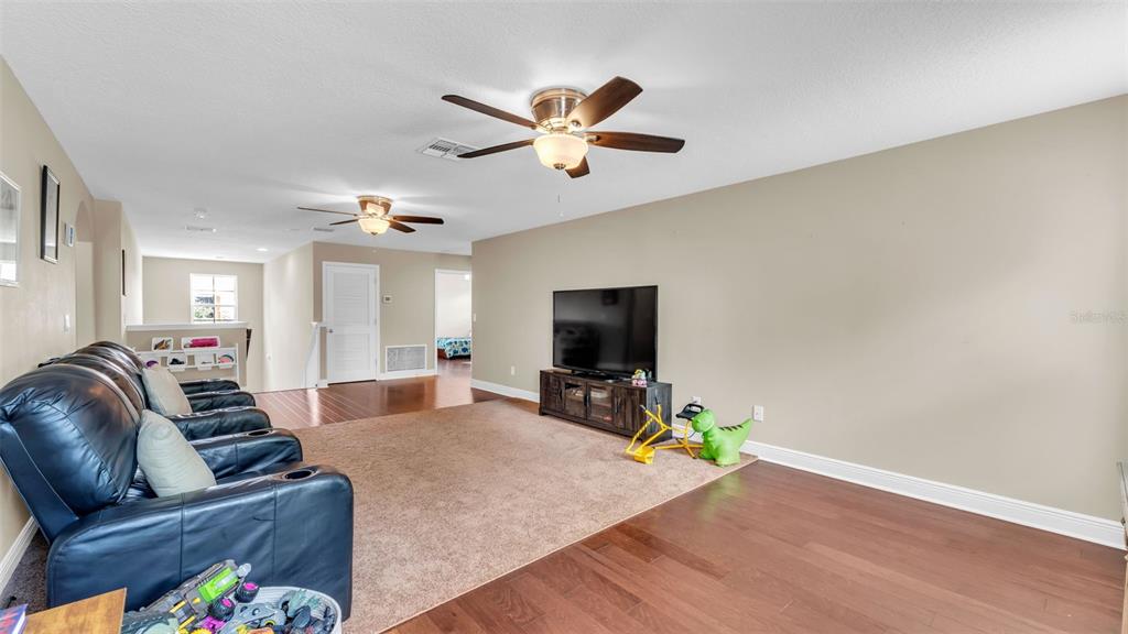132 Magneta Loop Auburndale, FL 33823 - Photo 30 of 56 a living room with furniture and a flat screen tv