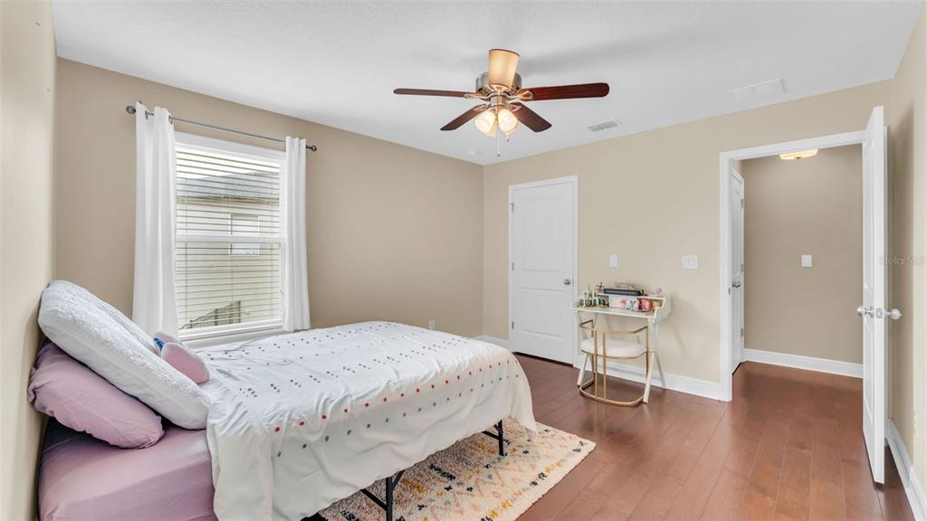 132 Magneta Loop Auburndale, FL 33823 - Photo 34 of 56 a bedroom with a bed and a chandelier