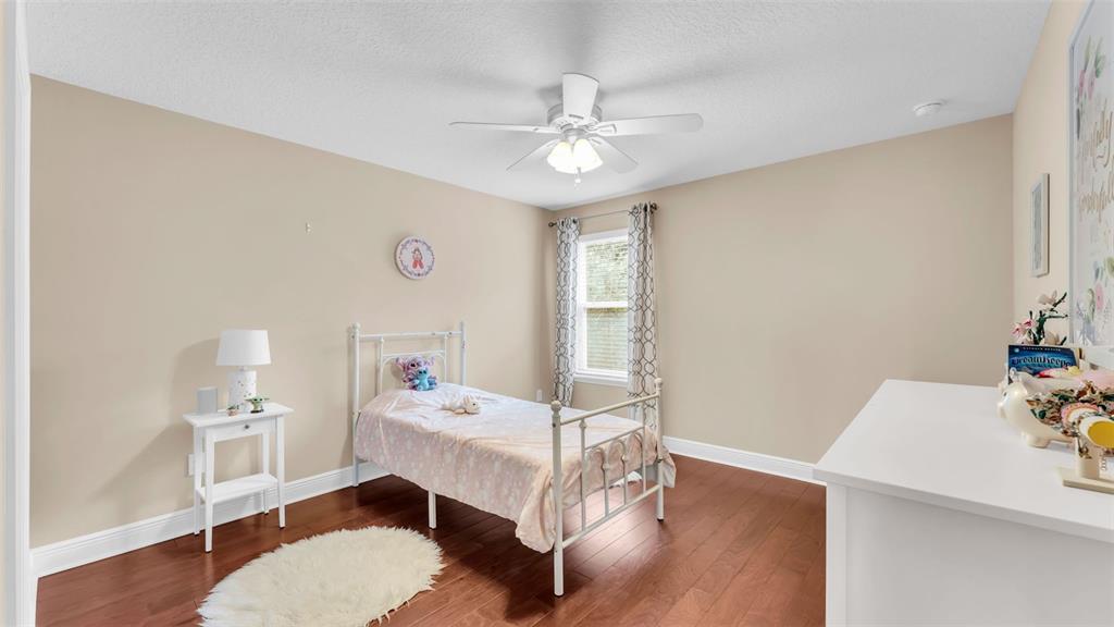 132 Magneta Loop Auburndale, FL 33823 - Photo 36 of 56 a bedroom with a bed and a chandelier
