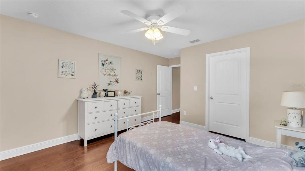 132 Magneta Loop Auburndale, FL 33823 - Photo 37 of 56 a bedroom with a bed and a dresser