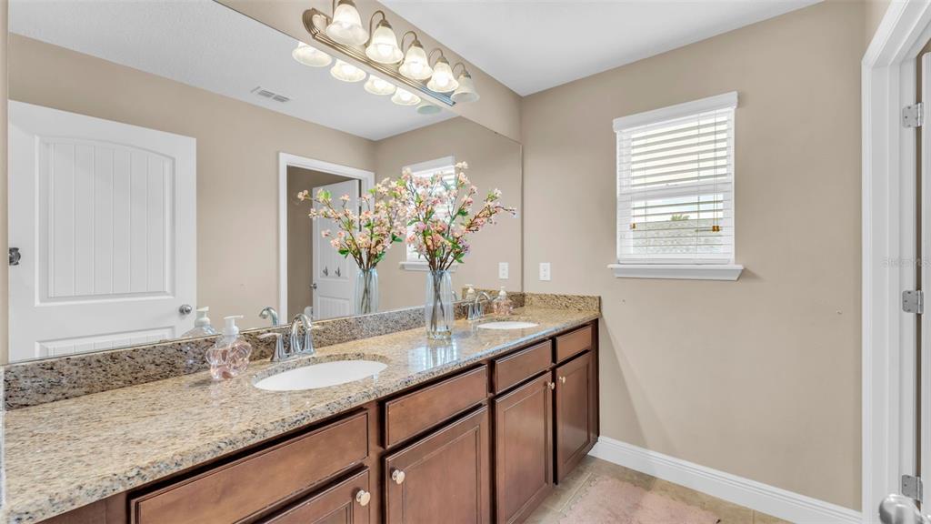 132 Magneta Loop Auburndale, FL 33823 - Photo 38 of 56 a bathroom with a granite countertop sink and a mirror
