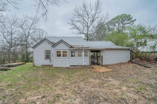 a backyard of a house with a fountain table and chairs