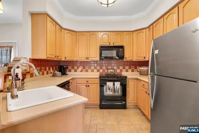 a kitchen with a refrigerator a stove a sink and a microwave