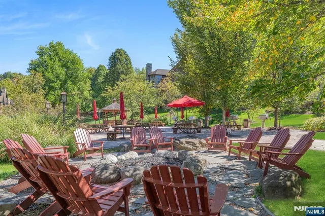 a view of a tables and chairs under an umbrella in a patio