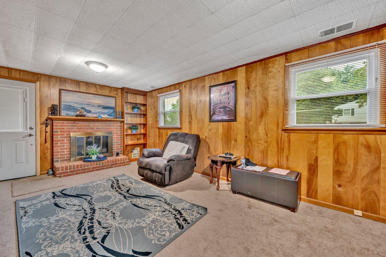 3131 Galloway Drive Roanoke, VA 24018 - Photo 11 of 37 a living room with furniture a fireplace and a large window