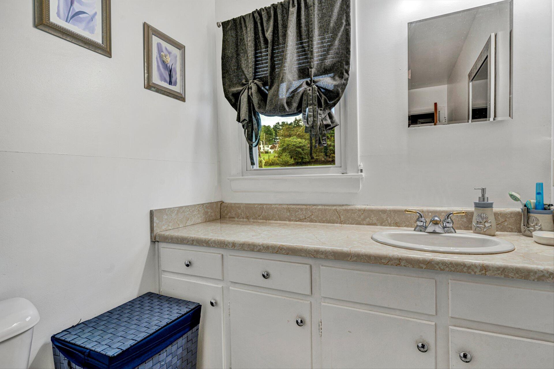 3131 Galloway Drive Roanoke, VA 24018 - Photo 13 of 37 a bathroom with a granite countertop sink and a mirror