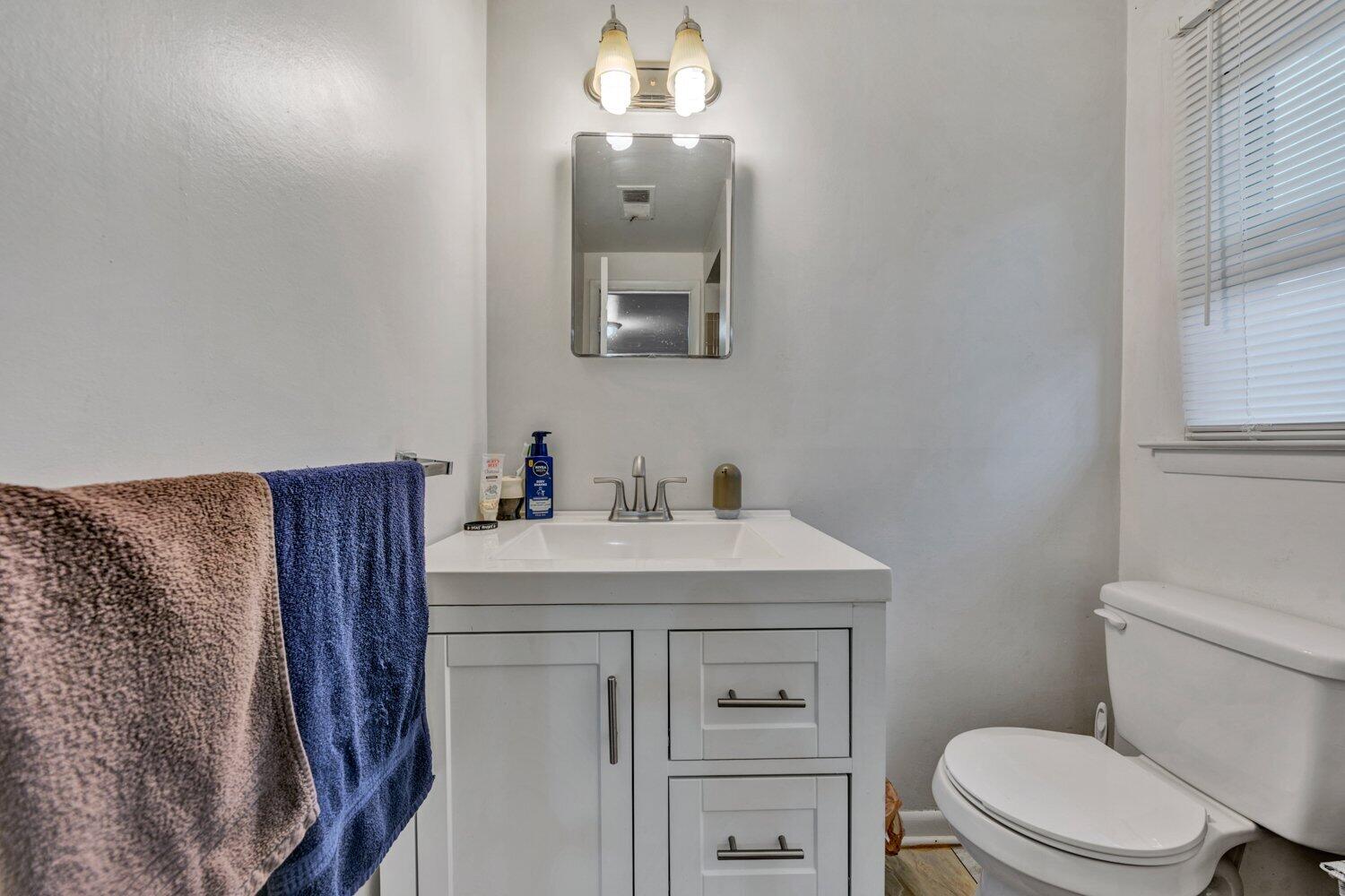 3131 Galloway Drive Roanoke, VA 24018 - Photo 21 of 37 a bathroom with a toilet a sink a vanity and mirror
