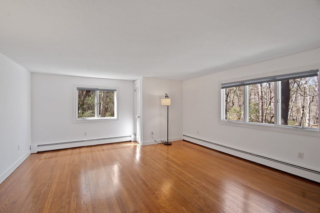 75 Westcott Road Harvard, MA 01451 - Photo 28 of 32 an empty room with wooden floor and windows