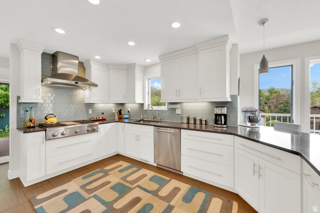 1506 Lakeview Drive Bountiful, UT 84010 - Photo 13 of 58 Kitchen with white cabinetry, stainless steel appliances, hanging light fixtures, and decorative backsplash