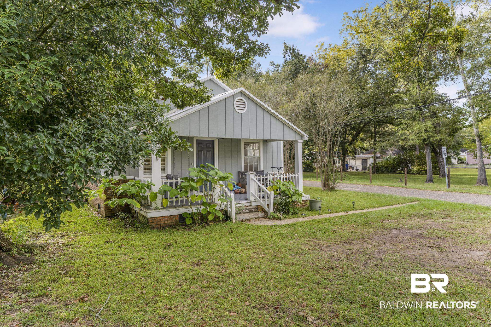 405 North Pine Street Foley, AL 36535 - Photo 4 of 33 Bungalow featuring covered porch, a front lawn, and board and batten siding