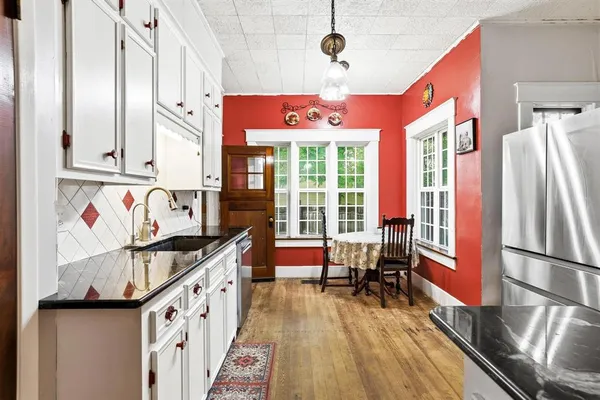 a kitchen with stainless steel appliances granite countertop a refrigerator and a stove