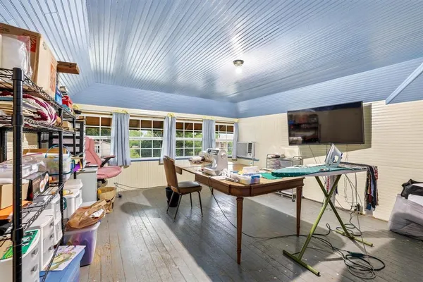 a view of a livingroom with furniture and a flat screen tv