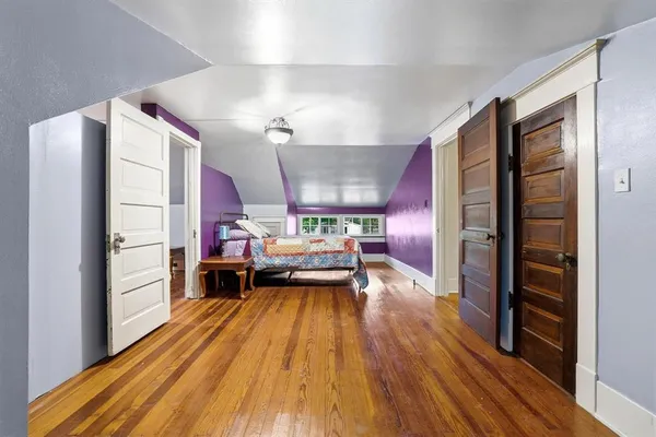 a kitchen view with wooden floor and stainless steel appliances