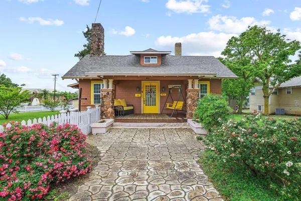 a front view of a house with a yard and fountain