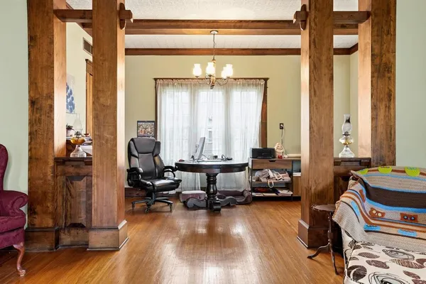 a living room with furniture and a chandelier