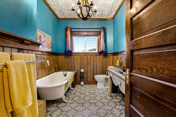 a bathroom with a toilet a sink and bathtub