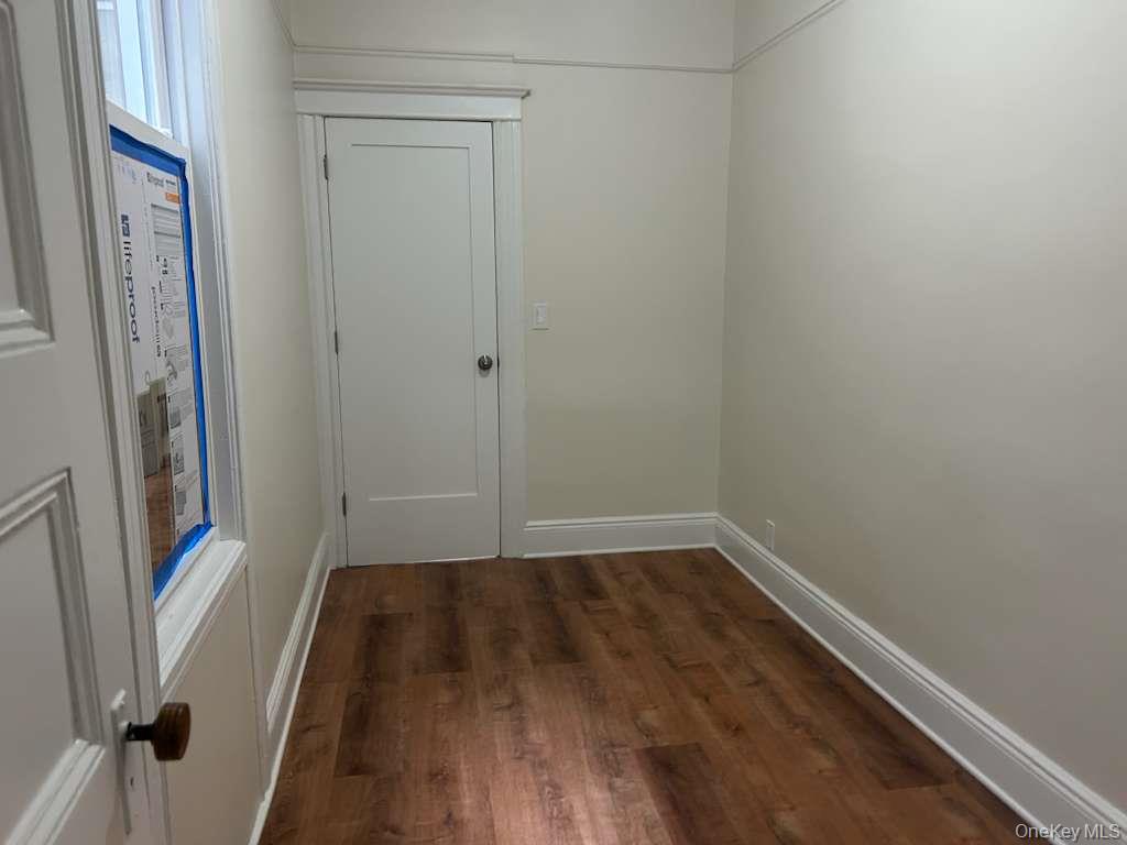 88-23 85th Street, Unit 1L Queens, NY 11421 - Photo 11 of 17 a view of a hallway with wooden floor and a sink