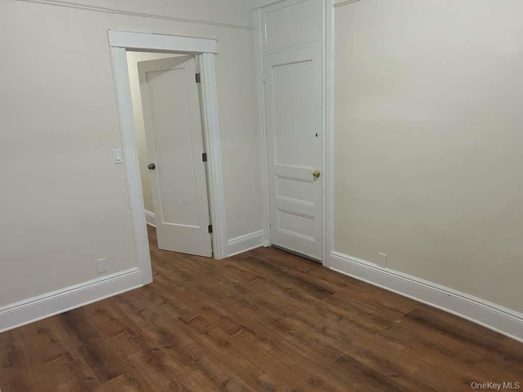88-23 85th Street, Unit 1L Queens, NY 11421 - Photo 12 of 17 a view of an empty room with wooden floor and a window
